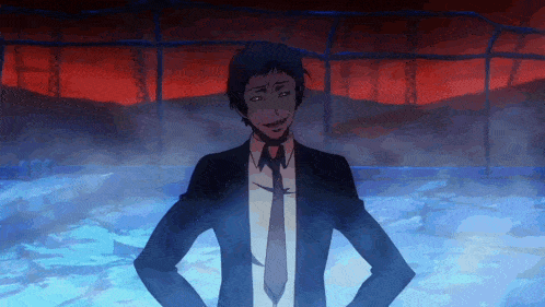 a man in a suit and tie is standing with his hands on his hips in front of a red background
