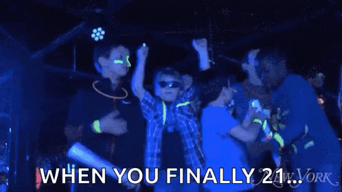 a group of children are dancing in a dark room while wearing glow in the dark glow sticks .