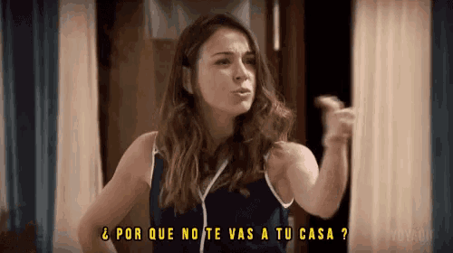 a woman in a blue tank top says " por que no te vas a tu casa "