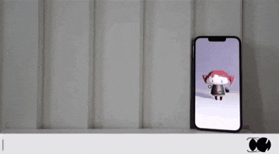 a cell phone with a cartoon character on the screen is displayed in a foreign language