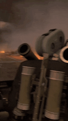 a blurred image of a cannon with a flame coming out of it
