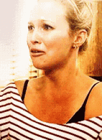 a woman is wearing a striped shirt and has a scar on her neck