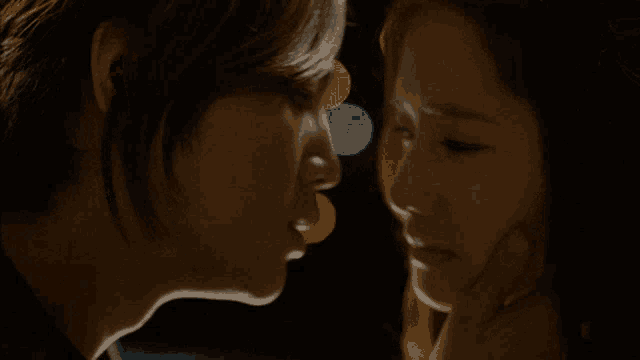 a man and a woman are looking at each other