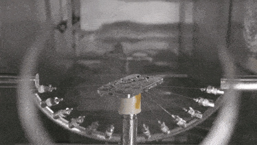 a cell phone is being cleaned in a machine with a yellow label that says ' samsung ' on it