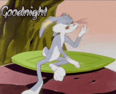 bugs bunny is sitting on a leaf with the words goodnight written above him