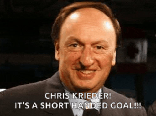a bald man in a suit is smiling and says chris frieder it 's a short handed goal .