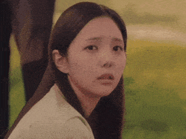 a close up of a woman 's face with a serious look on her face .