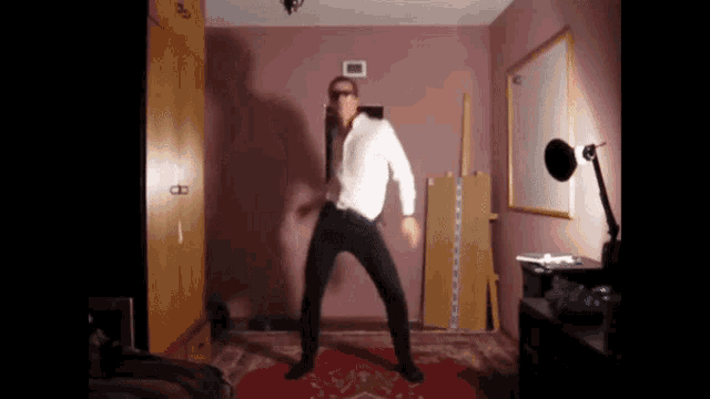 a man in a white shirt and black pants is dancing