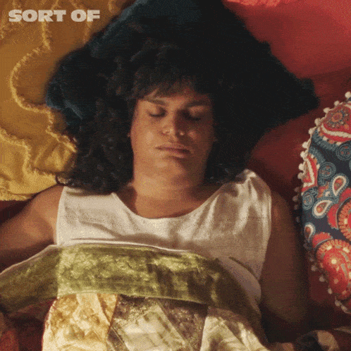 a woman laying on a bed with the words sort of written above her