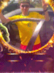 a blurry picture of a man wearing a yellow shirt and red shorts