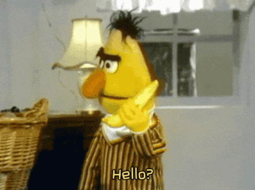 bert from sesame street is talking on a cell phone