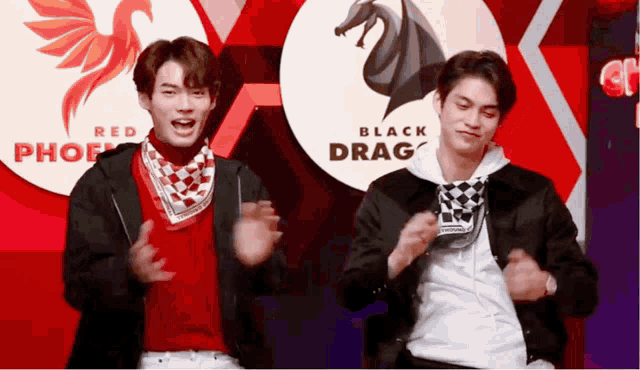 two men are dancing in front of a red phoenix and black drag sign
