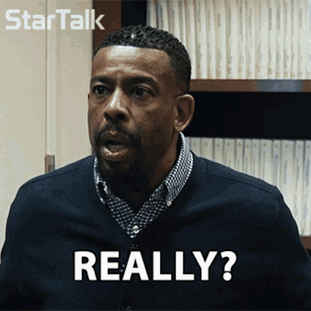 a man with a beard says really in front of a startalk logo