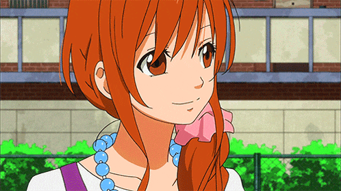 a girl with red hair is wearing a necklace with blue beads around her neck