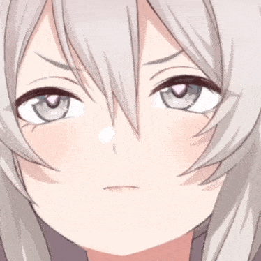 a close up of a girl 's face with a heart shaped pupil