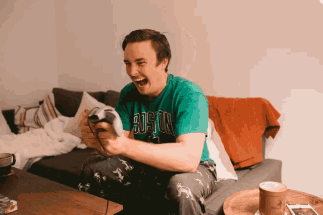 a man wearing a green shirt that says boston on it