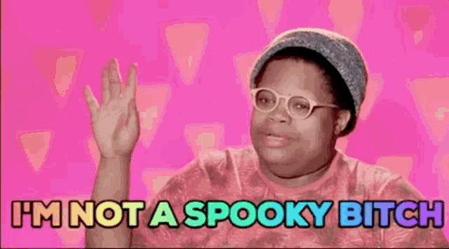 a woman wearing glasses and a hat is saying `` i 'm not a spooky bitch ''