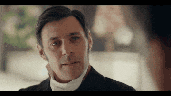 a close up of a man 's face in a suit and tie