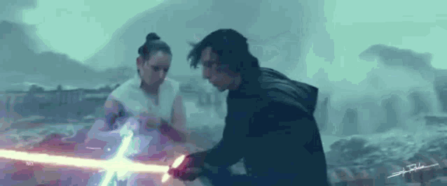 a man and a woman are standing next to each other holding lightsabers in a storm .