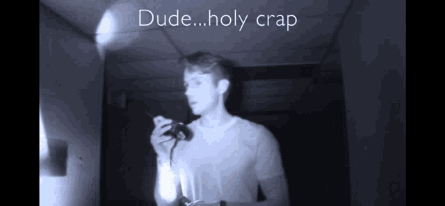 a man holding a flashlight in a dark room with the words dude holy crap below him