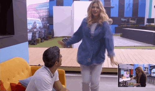 a woman in a denim jacket is dancing with a man in a white shirt