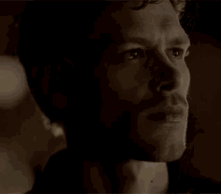 a close up of a man 's face in the dark .