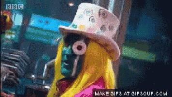 a pixelated image of a woman wearing a top hat and a yellow wig