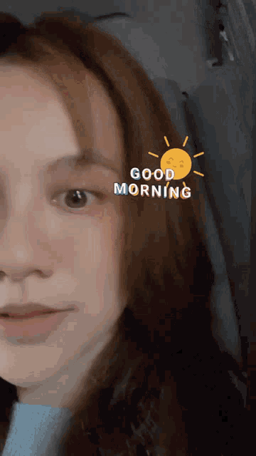 a close up of a woman 's face with a good morning sticker