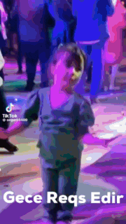 a little boy is dancing in a crowd with the words gece reqs edr written below him