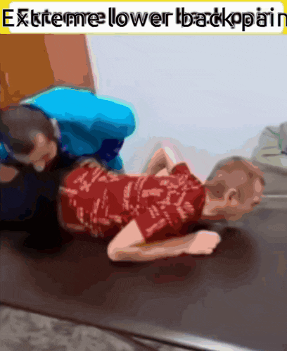 a child is laying on the floor with the words " extreme lower backpain " above him