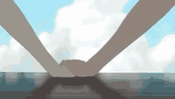 two people are holding hands over a table with a cloudy sky in the background .
