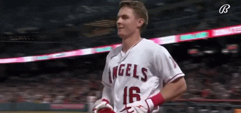 a baseball player wearing a white jersey with the number 16 on it .