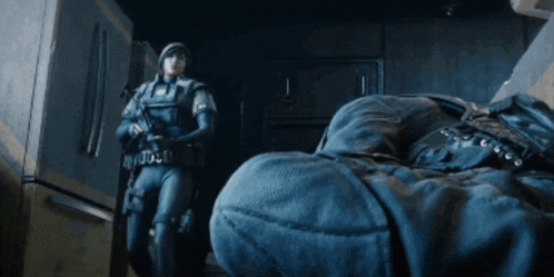 a soldier with a gun standing next to a person 's foot