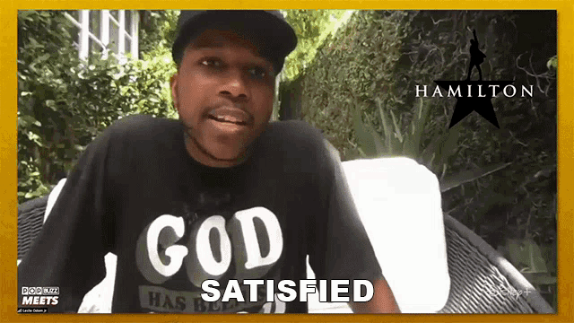 a man wearing a black shirt that says god satisfied