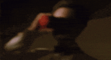 a man in a tuxedo drinking from a red cup