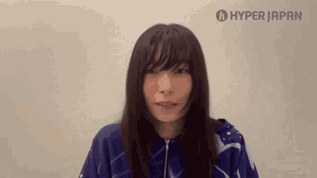 a woman is wearing a blue shirt with the word hyper japan on the bottom
