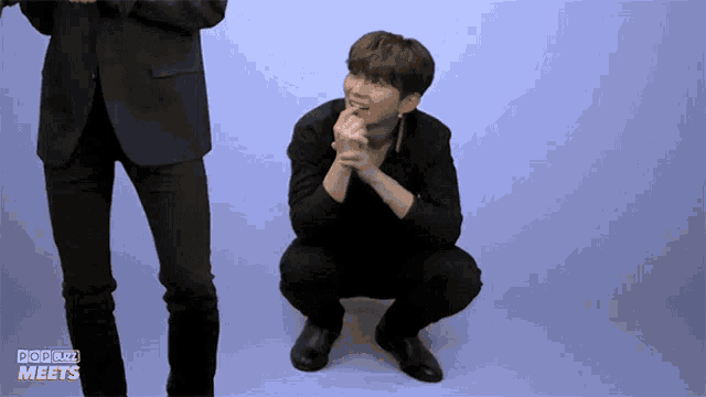 a man squatting down with the words pop buzz meets written on the bottom