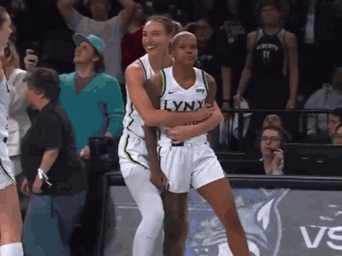 two lynx basketball players are hugging each other