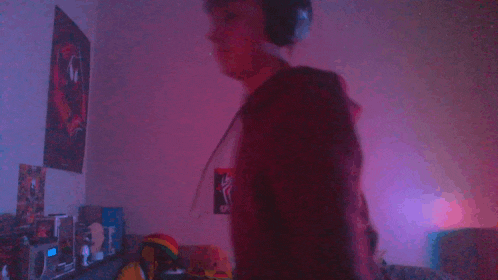 a blurry picture of a person dancing in a room with purple lights
