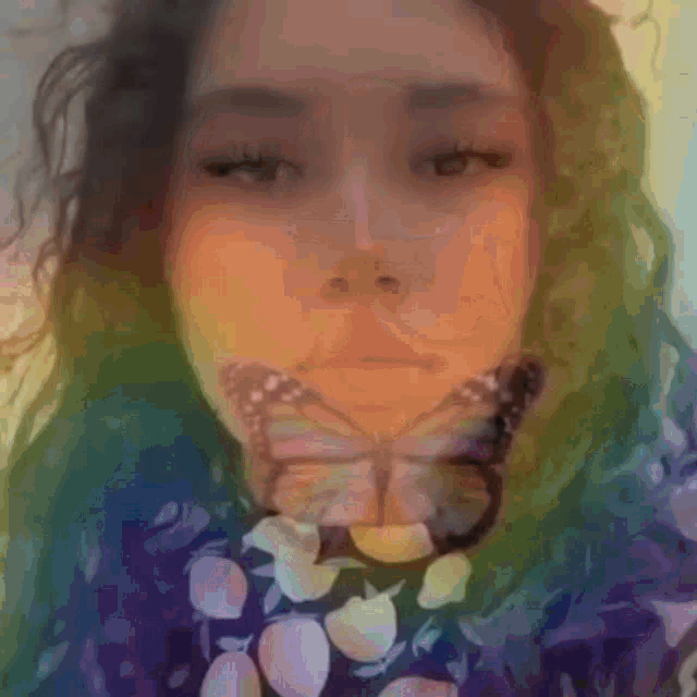 a woman with a butterfly on her face looks at the camera