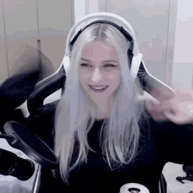 a woman with white hair is wearing headphones