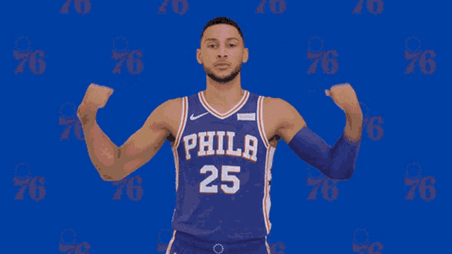 a man in a philadelphia 25 jersey flexes his muscles