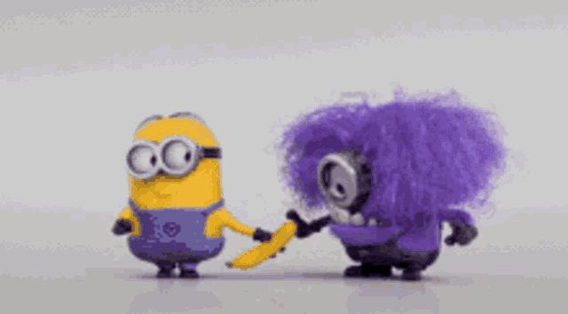 a yellow minion and a purple minion are holding hands and one is holding a banana
