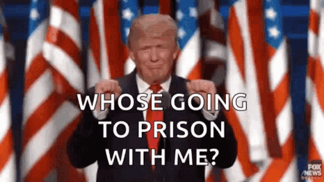 donald trump is giving a speech in front of an american flag and asking whose going to prison with me ?