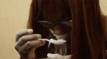 a close up of a person holding a spoon in their hand .