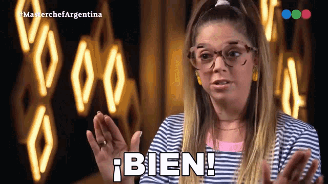 a woman wearing glasses and a striped shirt is saying bien