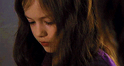 a close up of a young girl 's face with long hair