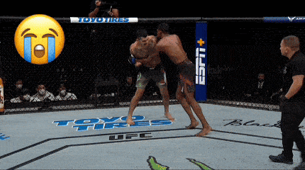 two men are fighting in a ufc ring with toyo tires on the floor