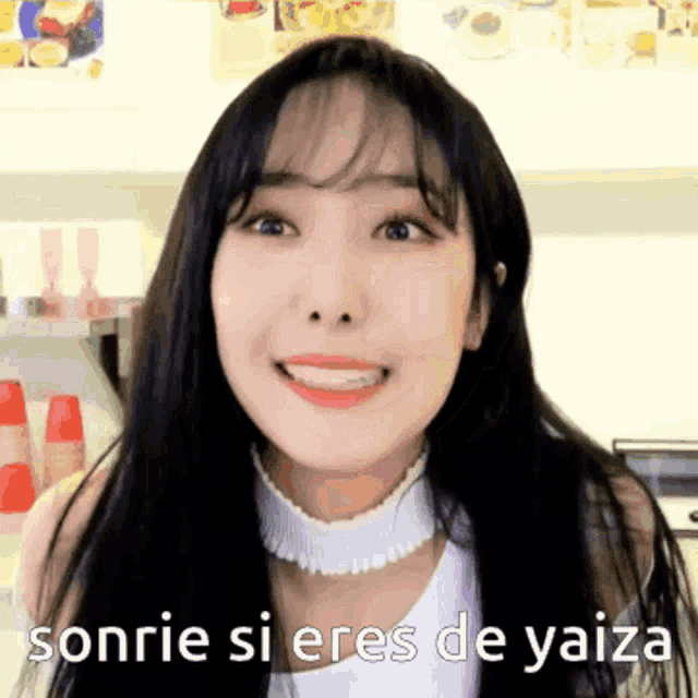 a woman is smiling with the words sonrie si eres de yaiza written below her