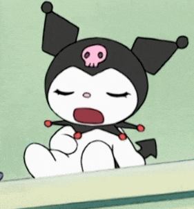 a cartoon character with a skull on its head is sitting on a table .